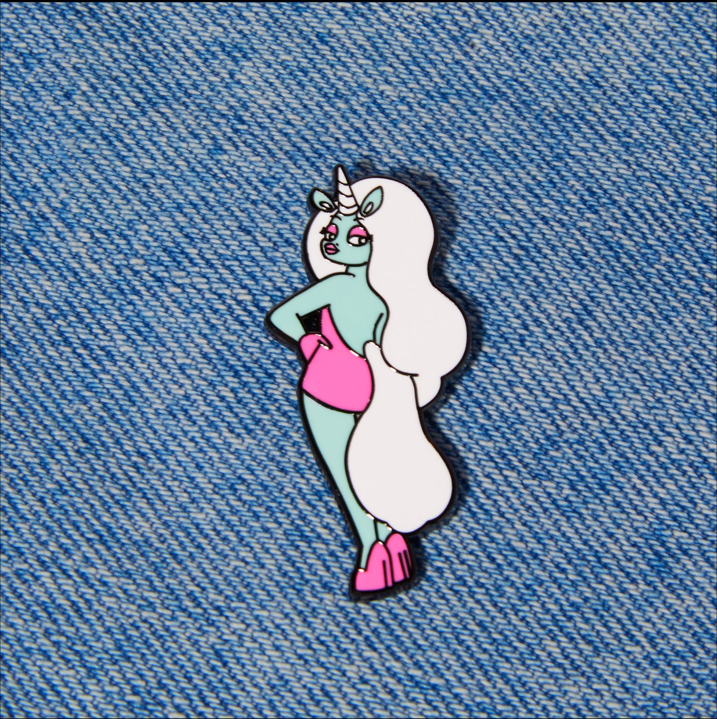 glow the unicorn pin on jeans