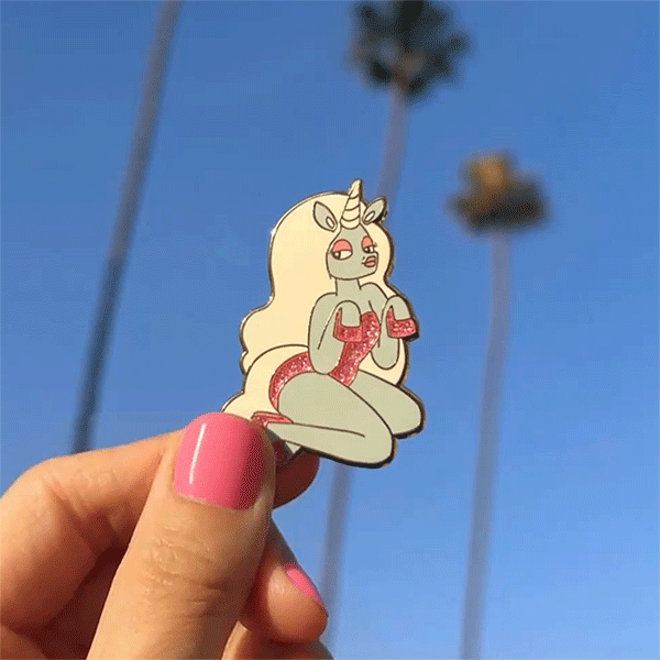 glitter pin shot in los angeles ca. glow the unicorn pin