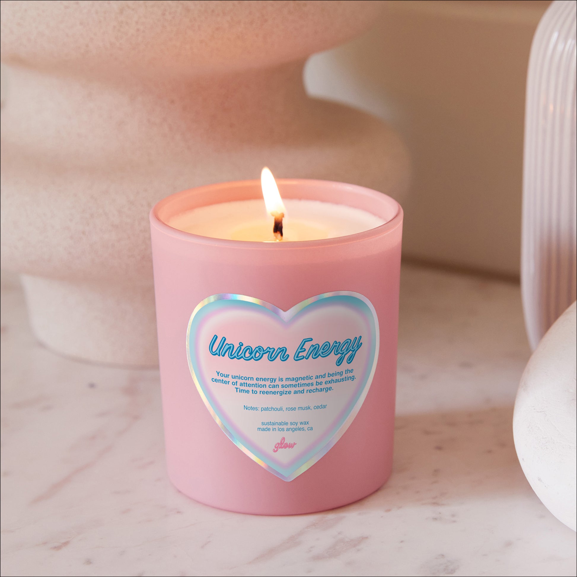 unicorn energy burning in pink jar candle