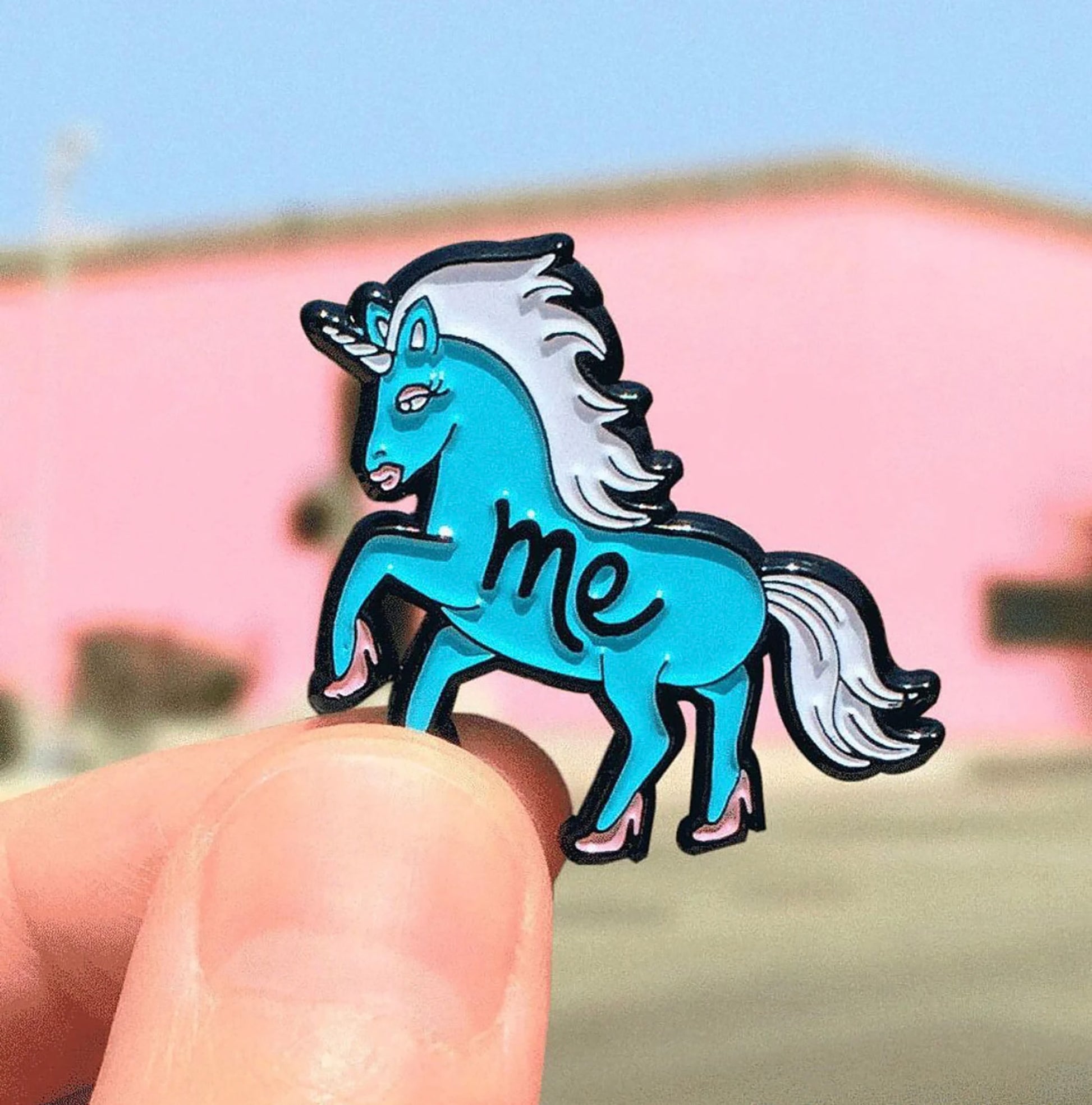 unicorn pin on pink wall