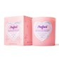 perfect candle next to packaging iin pink jar